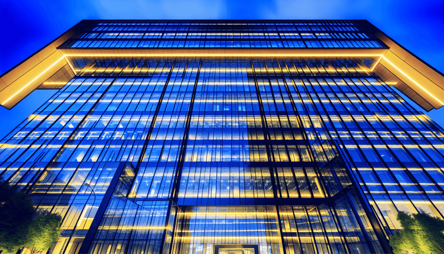 A modern tech building at dusk with glass windows reflecting the cityscape.