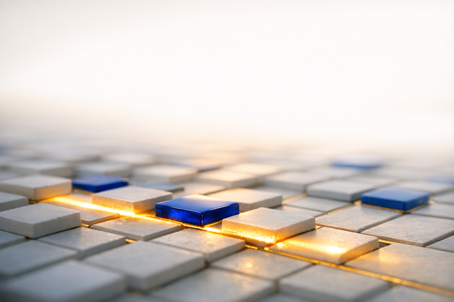 Pale modular tiles with blue glass accents and gold seams in soft morning light.
